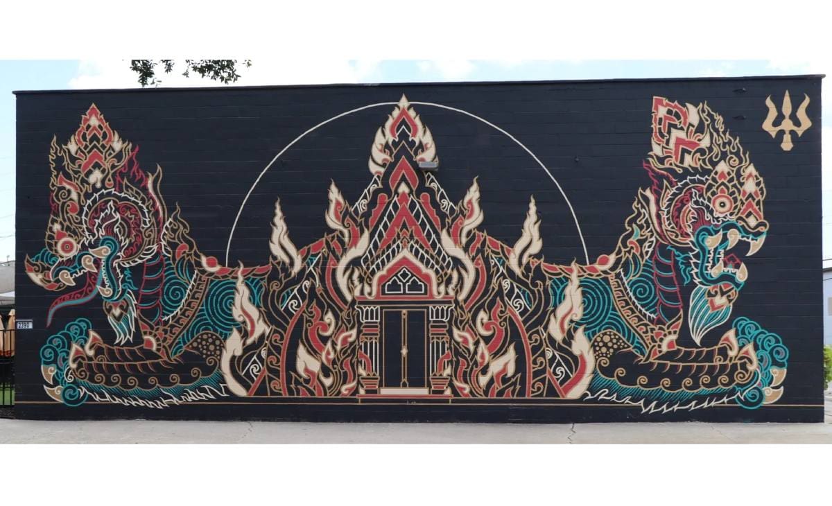 A black wallet with an oriental design on it.