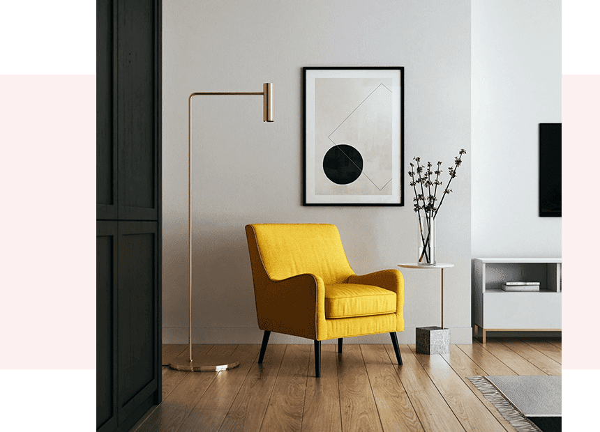 A yellow chair in front of a white wall.