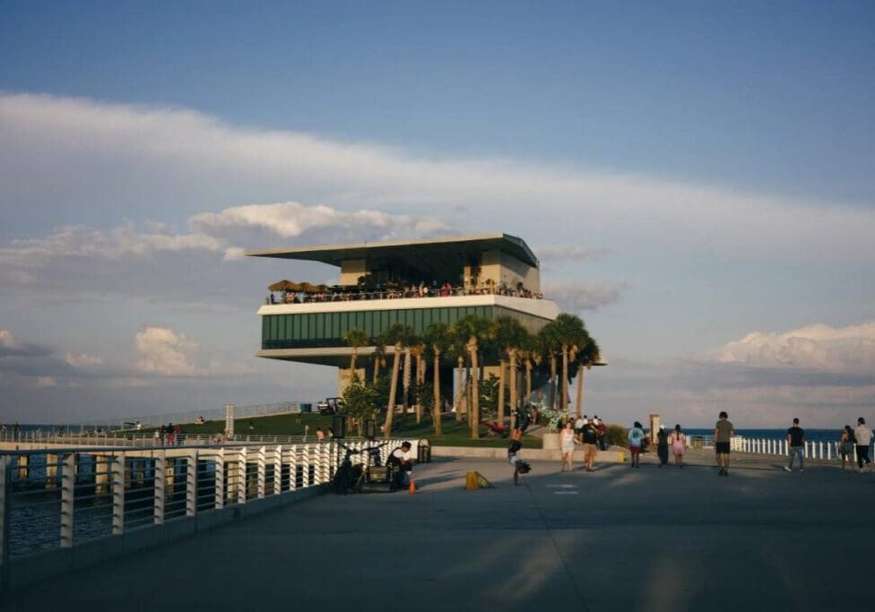 A building with people walking on the sidewalk.